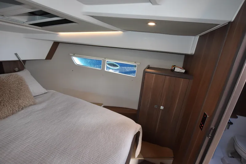 Indian Summer Yacht Photos Pics Luxurious cabin interior of 2016 Sealine C330 yacht with cozy bed and wooden cabinetry.