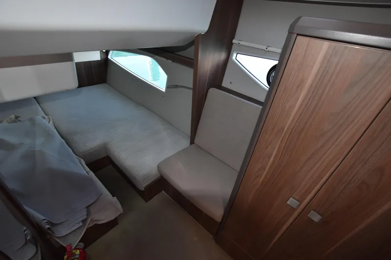 Indian Summer Yacht Photos Pics 2016 Sealine C330 cabin interior with bed, seating, and wooden cabinetry.