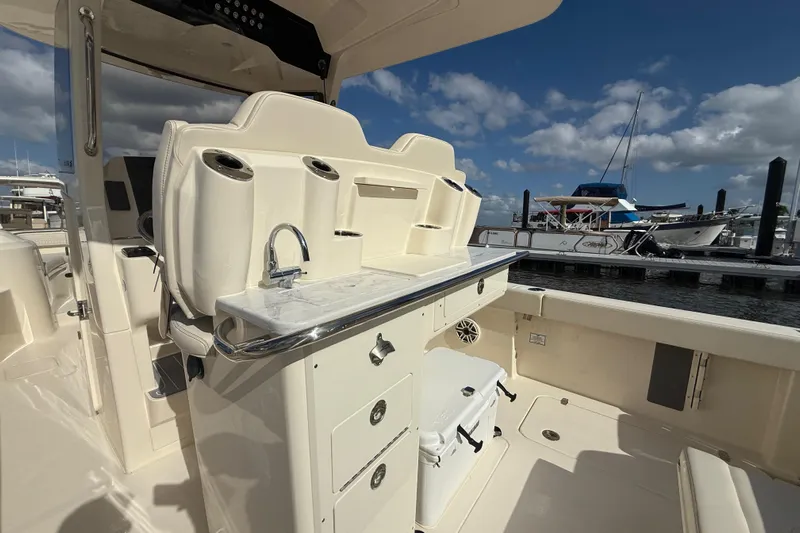  Yacht Photos Pics 2026 Scout 288 LXF boat interior with seating, sink, and storage at marina.