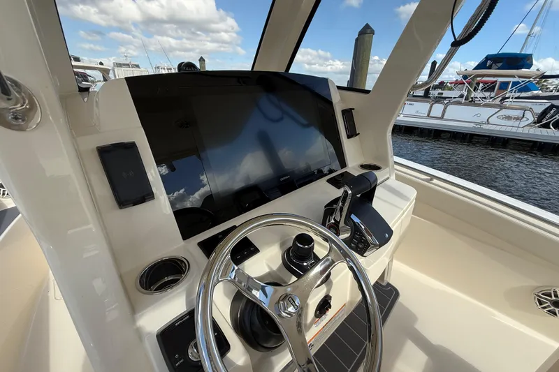  Yacht Photos Pics 2026 Scout 288 LXF boat dashboard with steering wheel and navigation display.