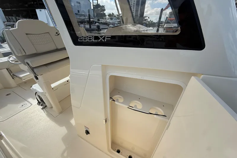  Yacht Photos Pics 2026 Scout 288 LXF boat interior with seating and storage compartment.