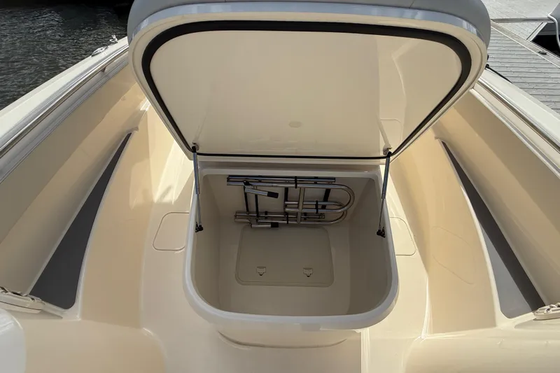  Yacht Photos Pics 2026 Scout 288 LXF boat storage compartment open, showcasing interior space.