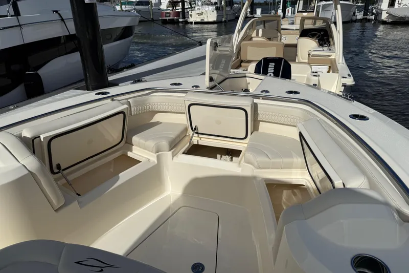  Yacht Photos Pics 2026 Scout 288 LXF boat interior with seating and storage at a marina.