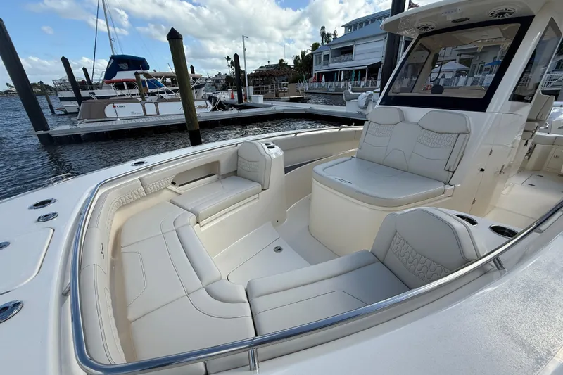  Yacht Photos Pics 2026 Scout 288 LXF boat with luxurious seating at a marina dock.