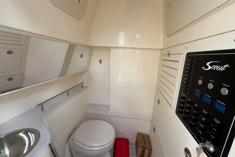  Yacht Photos Pics 2026 Scout 288 LXF boat interior with toilet, sink, and control panel.