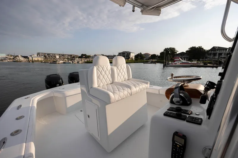  Yacht Photos Pics 2019 Willis 33 Center Console boat with white seating, docked in a marina.