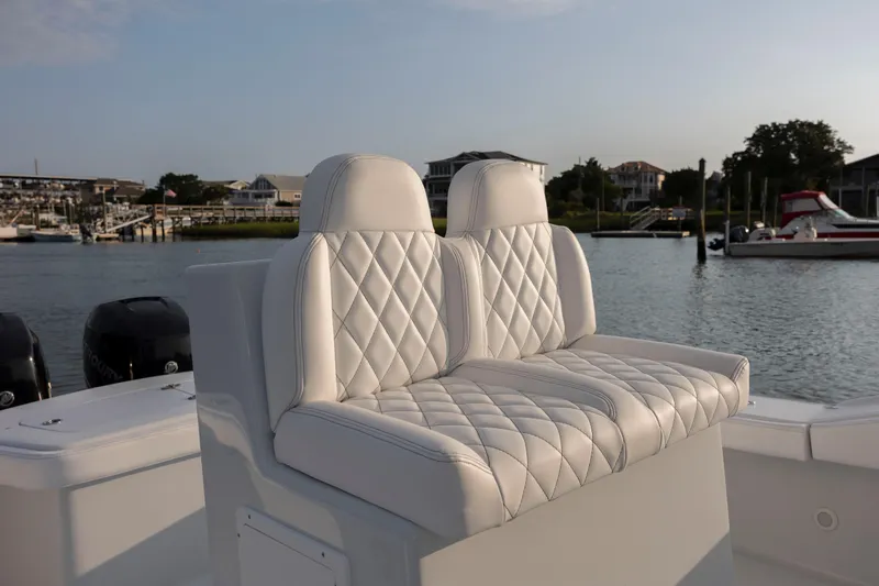  Yacht Photos Pics 2019 Willis 33 Center Console boat with white diamond-stitched seats docked at a marina.