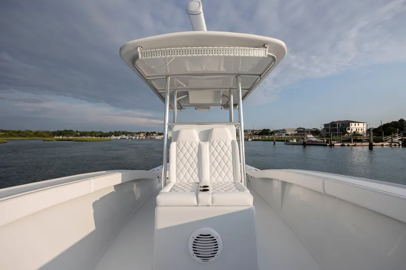  Yacht Photos Pics 2019 Willis 33 Center Console boat on calm waters with coastal background.