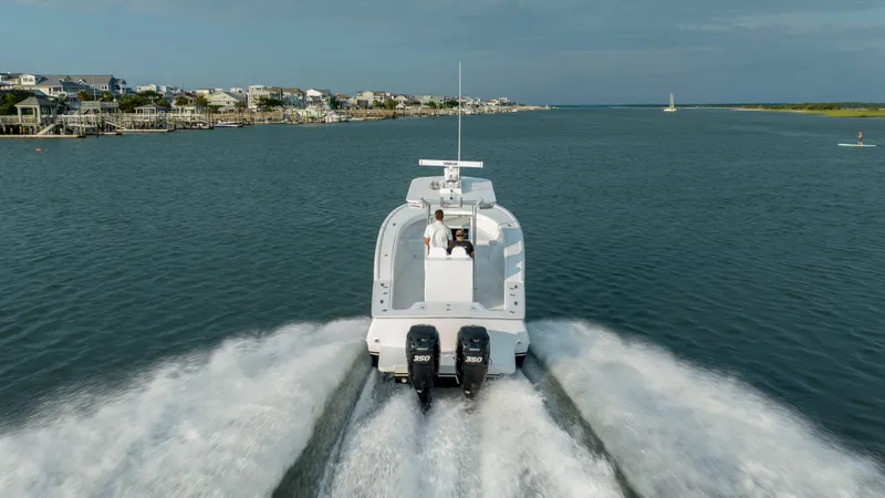  Yacht Photos Pics 2019 Willis 33 Center Console boat cruising on water with twin engines.