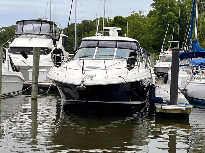 At Last Yacht Photos Pics 2004 Sea Ray 420 Sundancer yacht docked at marina with surrounding boats.