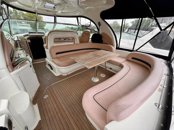 At Last Yacht Photos Pics 2004 Sea Ray 420 Sundancer interior with plush seating and wooden table.
