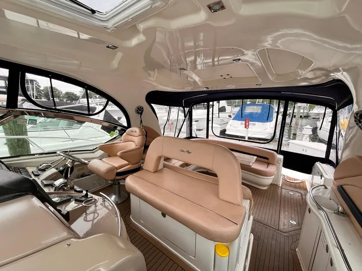 At Last Yacht Photos Pics Interior of a 2004 Sea Ray 420 Sundancer yacht with beige seating and helm.