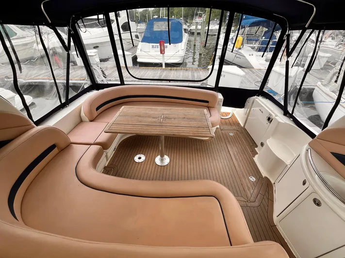 At Last Yacht Photos Pics Luxurious 2004 Sea Ray 420 Sundancer yacht interior with tan leather seating and wooden table.