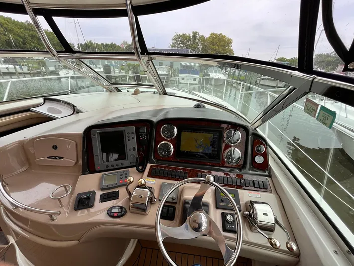 At Last Yacht Photos Pics Helm of 2004 Sea Ray 420 Sundancer with navigation instruments and steering wheel.