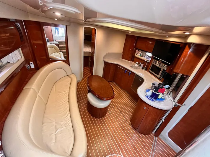 At Last Yacht Photos Pics Luxurious interior of a 2004 Sea Ray 420 Sundancer yacht with elegant wood finishes.