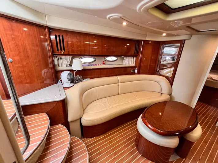 At Last Yacht Photos Pics Luxurious interior of 2004 Sea Ray 420 Sundancer yacht with leather seating and wooden finishes.