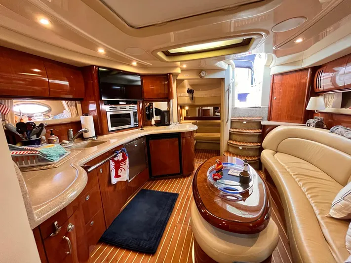 At Last Yacht Photos Pics Luxurious interior of a 2004 Sea Ray 420 Sundancer yacht with elegant wood finishes.