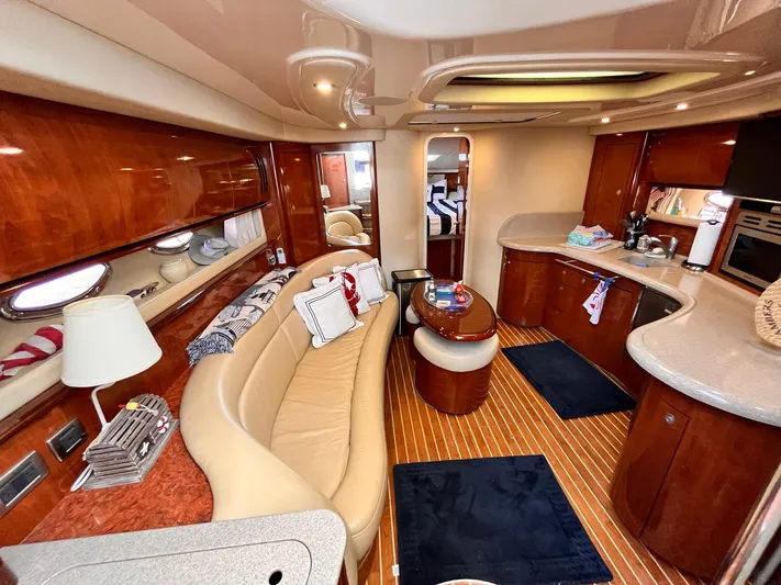 At Last Yacht Photos Pics Luxurious interior of a 2004 Sea Ray 420 Sundancer yacht with elegant wood finishes.