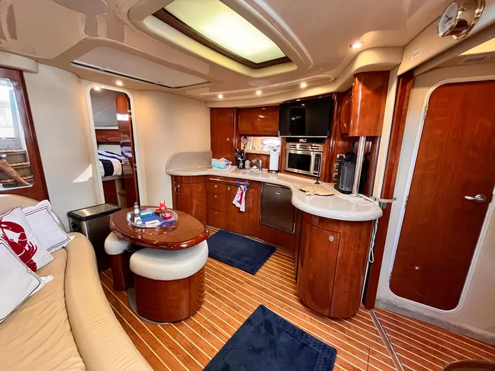 At Last Yacht Photos Pics Luxurious 2004 Sea Ray 420 Sundancer yacht interior with modern kitchen and cozy seating area.