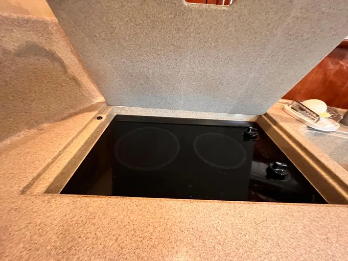 At Last Yacht Photos Pics Stovetop in 2004 Sea Ray 420 Sundancer yacht kitchen, with beige countertop.