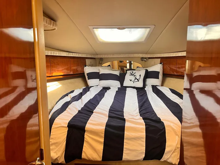 At Last Yacht Photos Pics Luxurious cabin interior of 2004 Sea Ray 420 Sundancer with striped bedding.