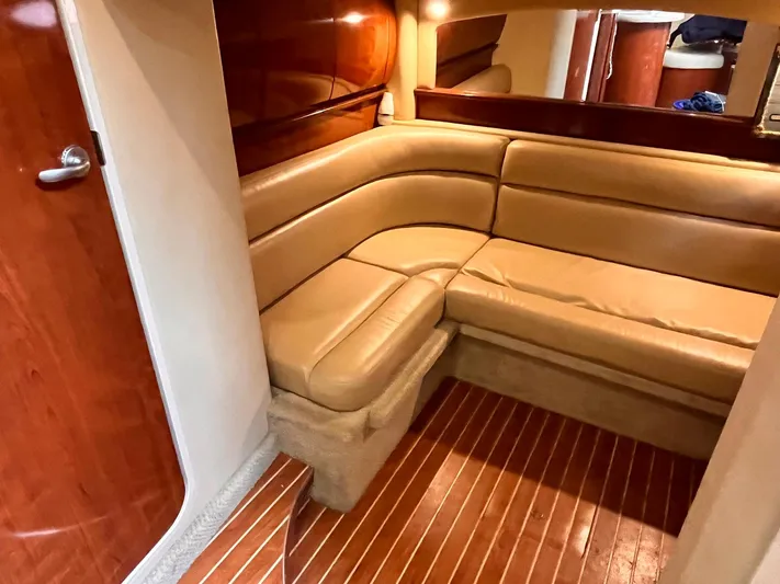 At Last Yacht Photos Pics Luxurious interior of 2004 Sea Ray 420 Sundancer with tan leather seating and wood accents.