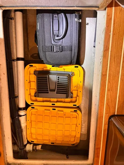 At Last Yacht Photos Pics Storage compartment on a 2004 Sea Ray 420 Sundancer with luggage and yellow containers.