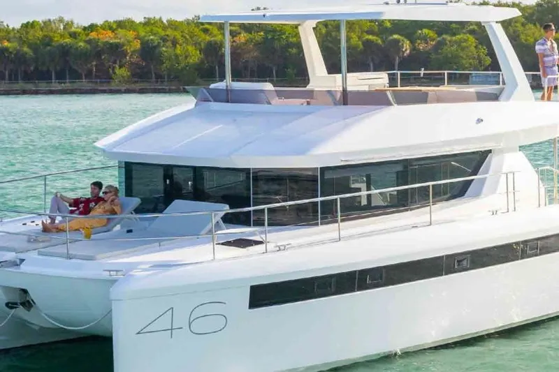  Yacht Photos Pics 2023 Leopard 46 Powercat yacht cruising with passengers, featuring sleek design and spacious deck.