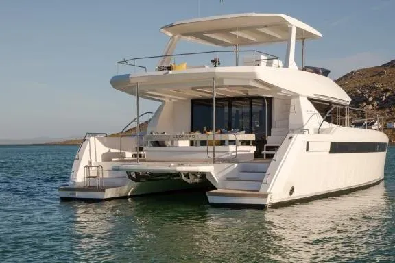  Yacht Photos Pics 2023 Leopard 46 Powercat yacht on calm water, showcasing modern design and spacious deck.