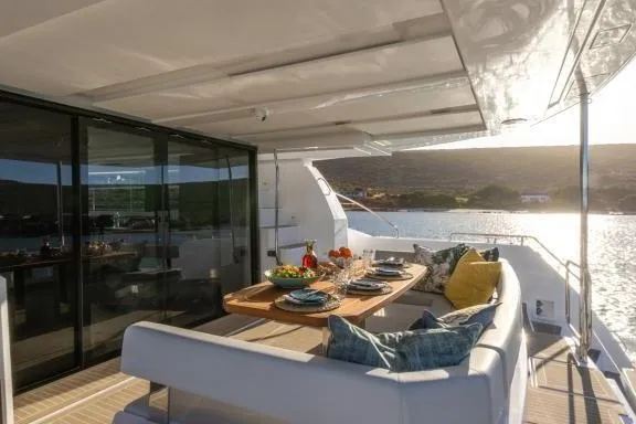  Yacht Photos Pics Luxurious 2023 Leopard 46 Powercat yacht with elegant outdoor dining area at sunset.