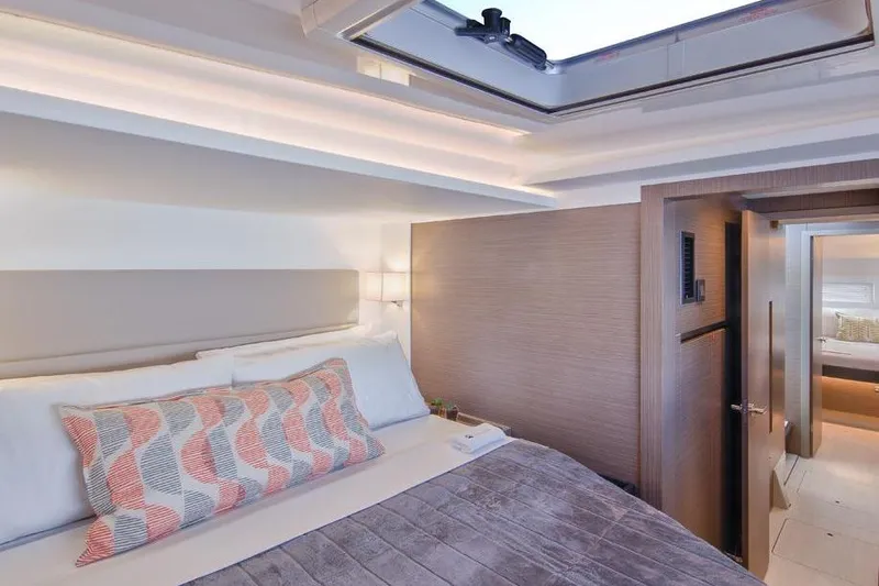  Yacht Photos Pics Luxurious bedroom interior of 2023 Leopard 46 Powercat yacht with modern design and skylight.