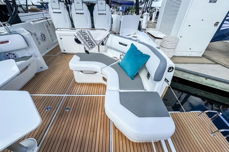  Yacht Photos Pics Luxurious seating area on 2026 Wellcraft 38 T-Top boat with teak flooring and cushions.