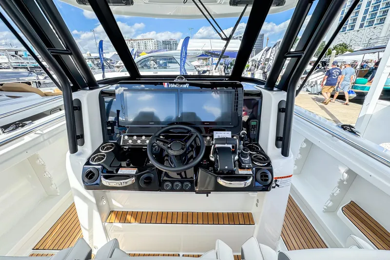  Yacht Photos Pics 2026 Wellcraft 38 T-Top boat helm with advanced navigation system and sleek design.