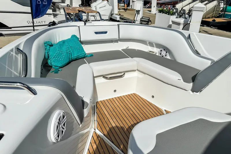  Yacht Photos Pics Luxurious seating area on 2026 Wellcraft 38 T-Top boat with teal cushion and wood flooring.