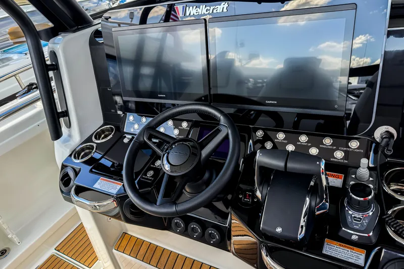  Yacht Photos Pics 2026 Wellcraft 38 T-Top boat dashboard with dual screens and modern controls.