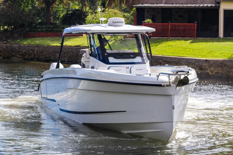  Yacht Photos Pics 2026 Wellcraft 38 T-Top boat cruising on a calm waterway.