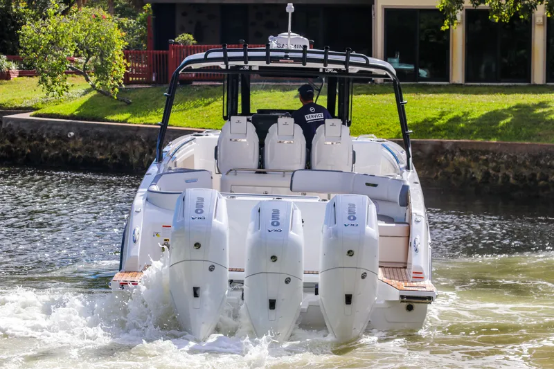  Yacht Photos Pics 2026 Wellcraft 38 T-Top boat with quad engines cruising on a scenic waterway.