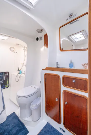 Nogal Yacht Photos Pics Luxurious 2009 Chris White Atlantic 57 yacht bathroom with wooden cabinets and modern fixtures.