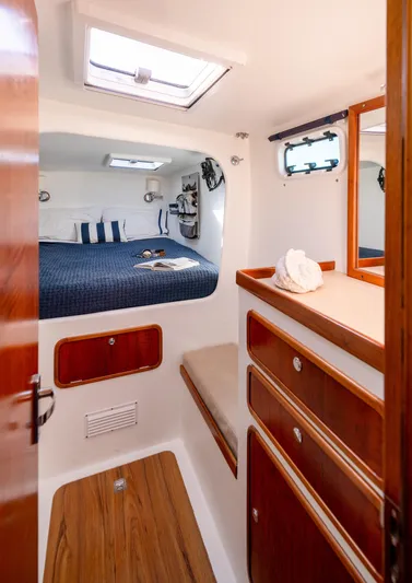 Nogal Yacht Photos Pics Luxurious cabin interior of 2009 Chris White Atlantic 57 yacht with cozy bed and wooden accents.