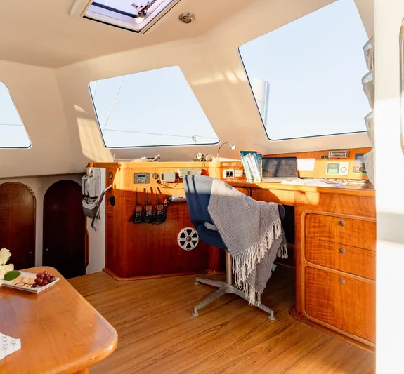 Nogal Yacht Photos Pics Luxurious interior of 2009 Chris White Atlantic 57 yacht with wooden furnishings and navigation station.