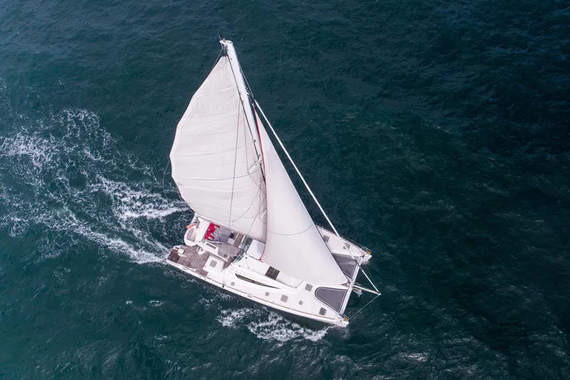 Tehiya Yacht Photos Pics Aerial view of 2009 Privilege 615 sailing yacht on open sea.