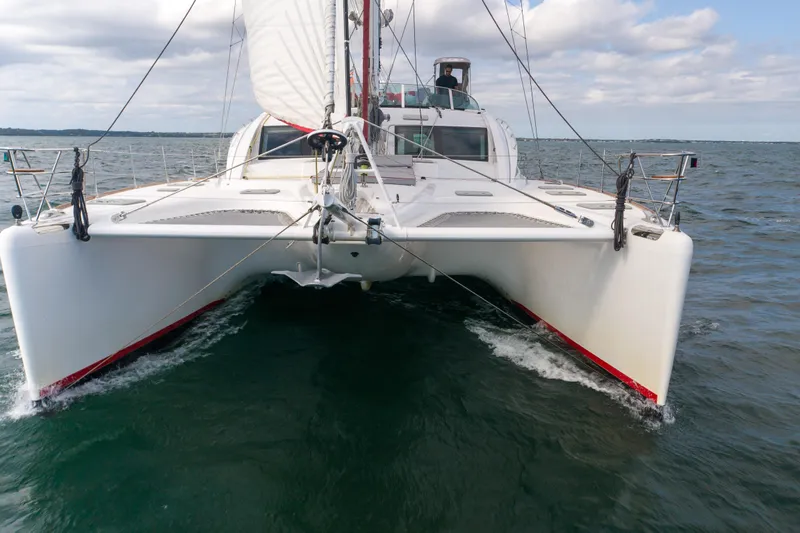 Tehiya Yacht Photos Pics Sailing catamaran Privilege 615, 2009 model, cruising on open water under cloudy skies.