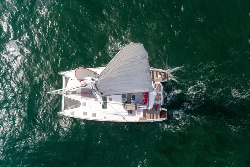 Tehiya Yacht Photos Pics Aerial view of 2009 Privilege 615 catamaran sailing on open sea.
