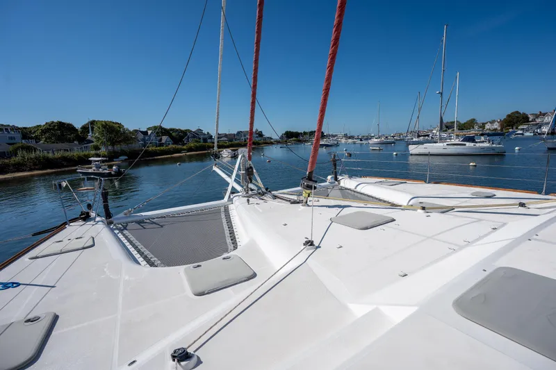 Tehiya Yacht Photos Pics 2009 Privilege 615 catamaran docked in a serene marina with clear blue skies.