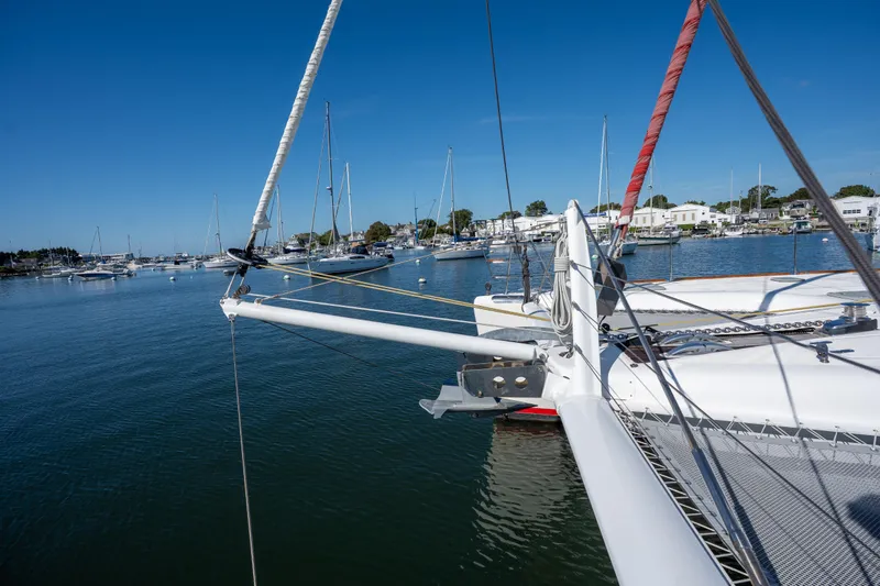 Tehiya Yacht Photos Pics Sailing catamaran Privilege 615, 2009 model, docked in a serene marina under clear blue skies.
