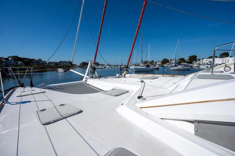 Tehiya Yacht Photos Pics 2009 Privilege 615 yacht docked in a serene marina under clear blue skies.