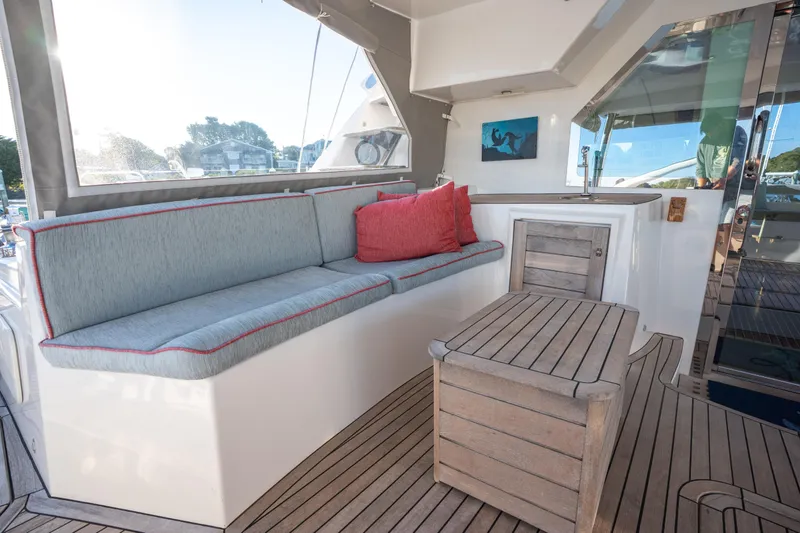 Tehiya Yacht Photos Pics Luxurious 2009 Privilege 615 yacht interior with cushioned seating and wooden table.