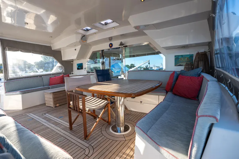 Tehiya Yacht Photos Pics Luxurious 2009 Privilege 615 yacht interior with elegant seating and wooden table.