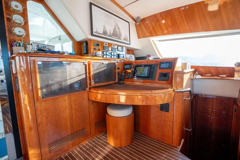 Tehiya Yacht Photos Pics Luxurious 2009 Privilege 615 yacht interior with navigation station and wooden cabinetry.