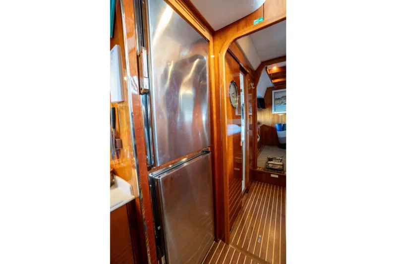 Tehiya Yacht Photos Pics Luxurious 2009 Privilege 615 yacht interior with wood paneling and stainless steel appliances.